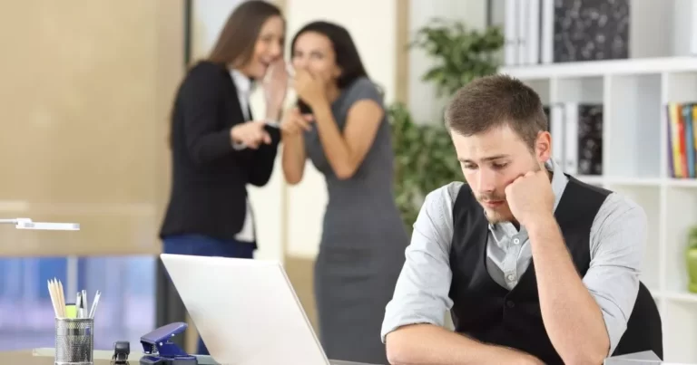 Man sitting at desk using a computer to locate information for complainants