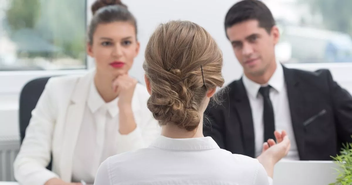 Male and female investigators discussing a workplace investigation with a female worker