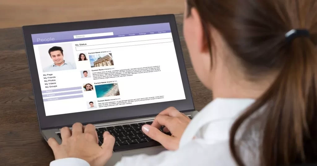 Woman working at laptop computer, conducting a skip trace investigation